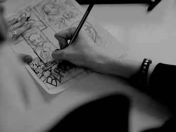 Person illustrating a comic book